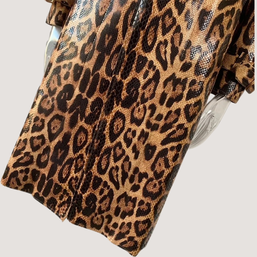 Luipaardprint jas met gedetailleerd patroon, modieuze dameskleding, trendy dierenprint, close-up stoftextuur, stijlvolle herfst- en wintermode.