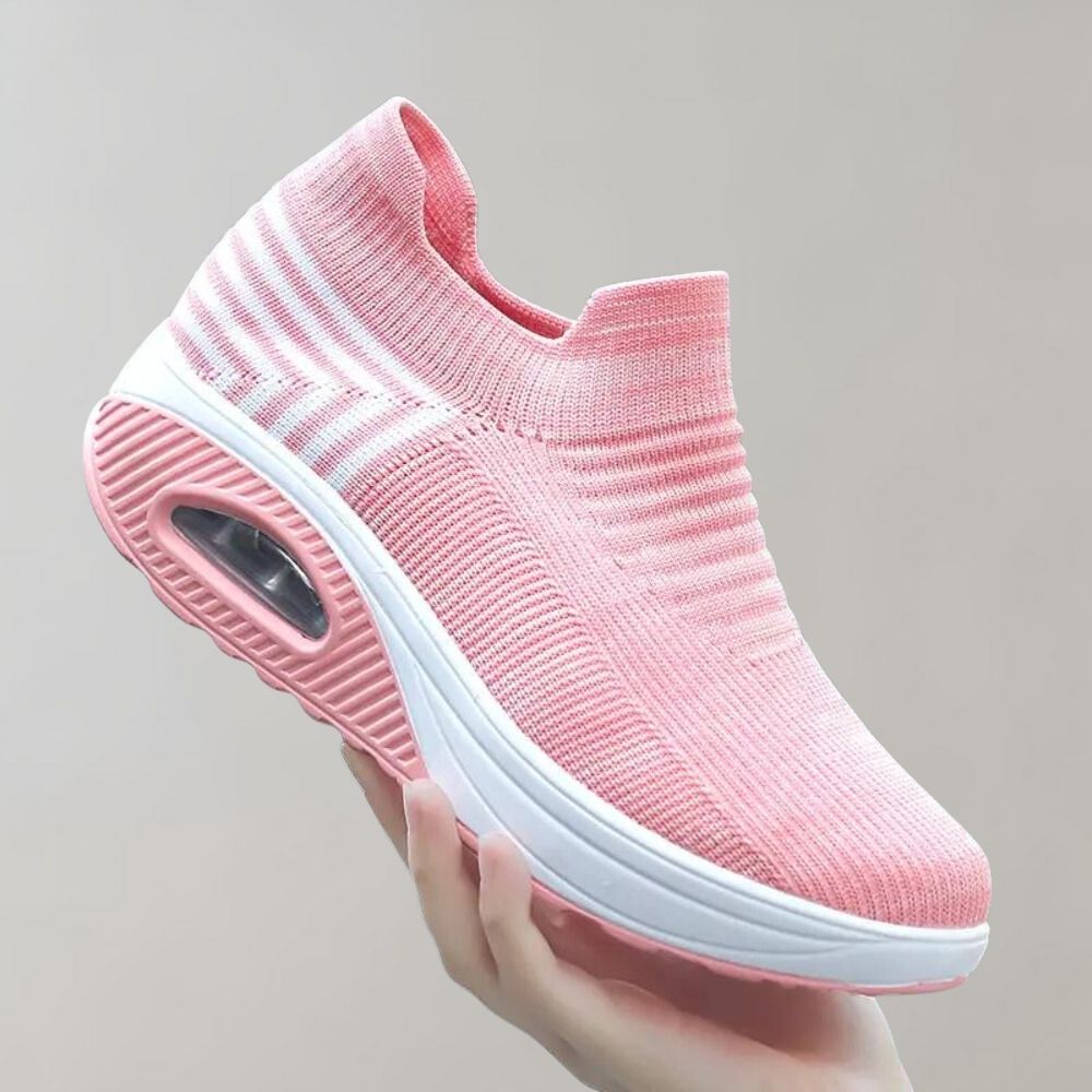 Roze dames sneaker met luchtkussen zool, gebreid bovenwerk en slip-on design. Comfortabele sportschoen voor dagelijks gebruik.