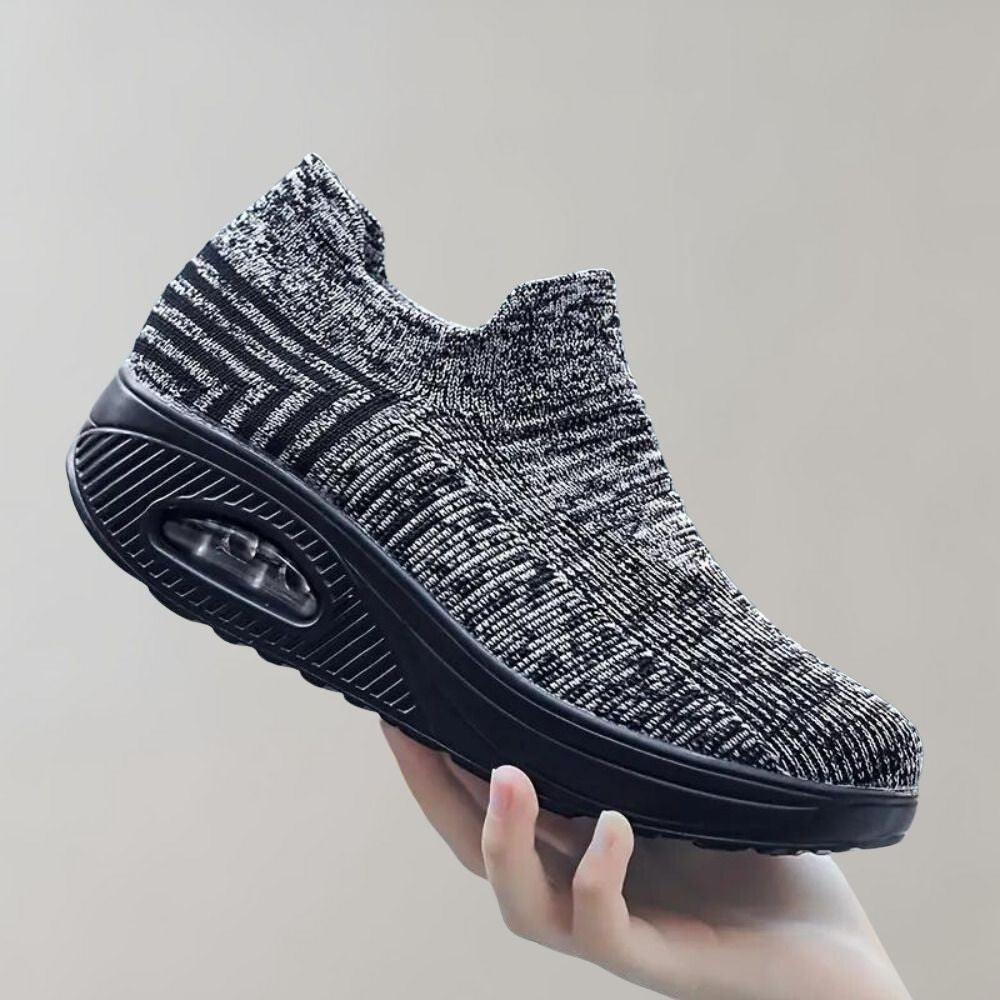 Donkergrijze gebreide sneaker met verhoogde zool en luchtkussen, comfortabel en stijlvol, ideaal voor dagelijks gebruik en wandelen.