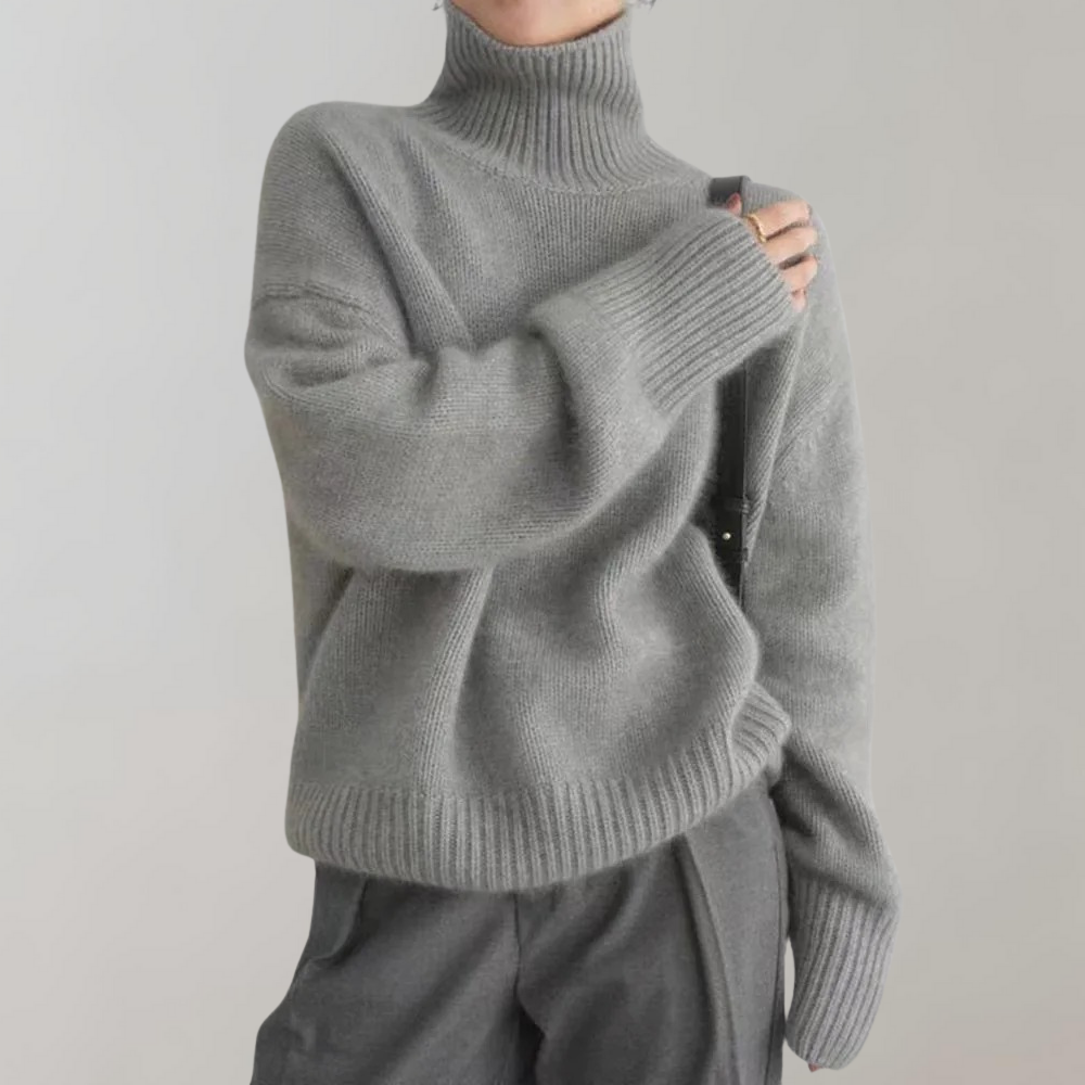 Grijze coltrui dames, zachte gebreide stof, casual wintermode, comfortabele oversized pasvorm, trendy kleding, stijlvolle warme trui.