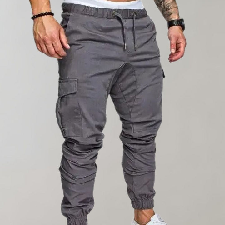 Grijze cargobroek voor heren met elastische tailleband en zakken, ideaal voor casual en sportieve outfits. Comfortabele pasvorm, trendy design.