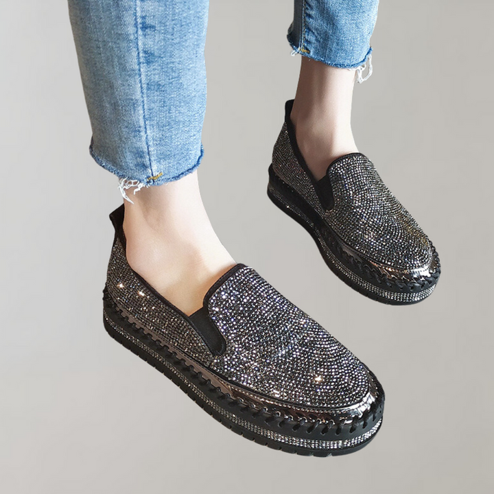Zwarte damessneakers met glinsterende strass-steentjes, slip-on ontwerp, comfortabele dikke zool. Perfect voor modieuze casual outfits.