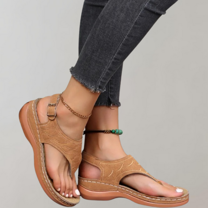 Bruine sandalen met open teen en verstelbare riem, gedragen met donkere jeans. Comfortabele zomerschoenen voor dames. Perfect voor casual outfits.