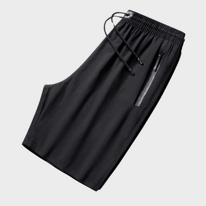 Zwarte sportieve korte broek met elastische tailleband, trekkoord en ritszakken. Ideaal voor casual en actieve outfits. Comfortabele pasvorm.