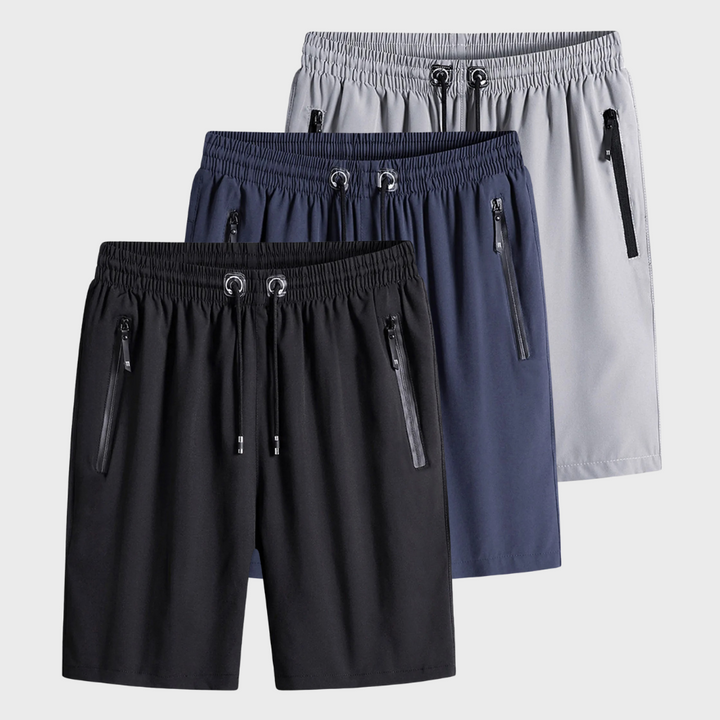Drie sportieve herenshorts in zwart, blauw en grijs met elastische tailleband en ritssluitingen. Ideaal voor fitness en casual wear.