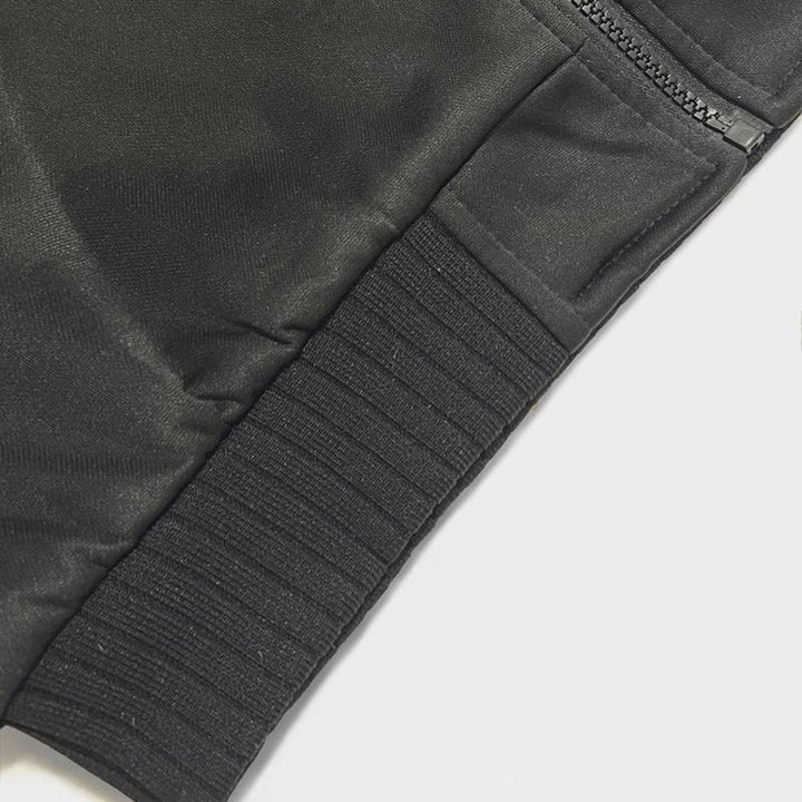 Zwarte sportbroek met elastische tailleband en ritssluiting, close-up. Hoogwaardige fitnesskleding, comfortabel en duurzaam materiaal.