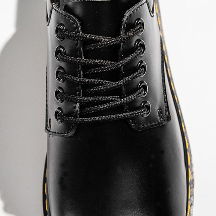 Zwarte leren veterlaars met gele stiksels, close-up. Stijlvolle en duurzame schoenen, perfect voor casual en formele gelegenheden.