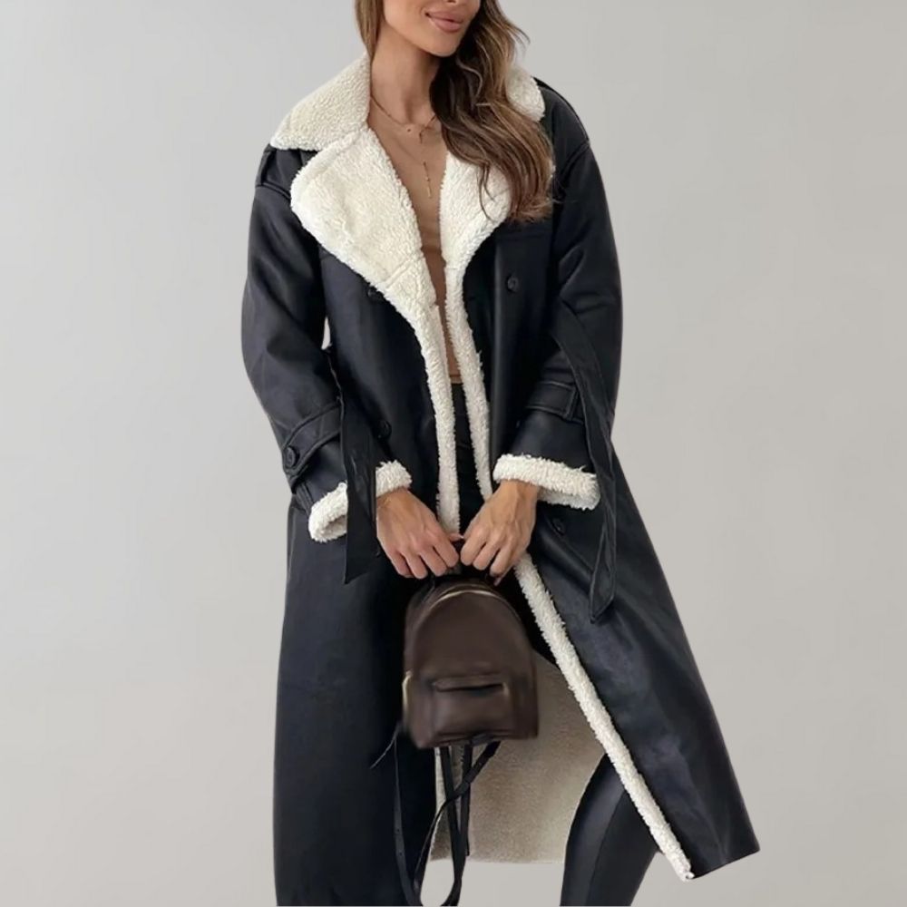 Dames winterjas zwart, lang model met witte voering, modieuze uitstraling. Perfect voor koude seizoenen. Wintermode, warme damesjas.
