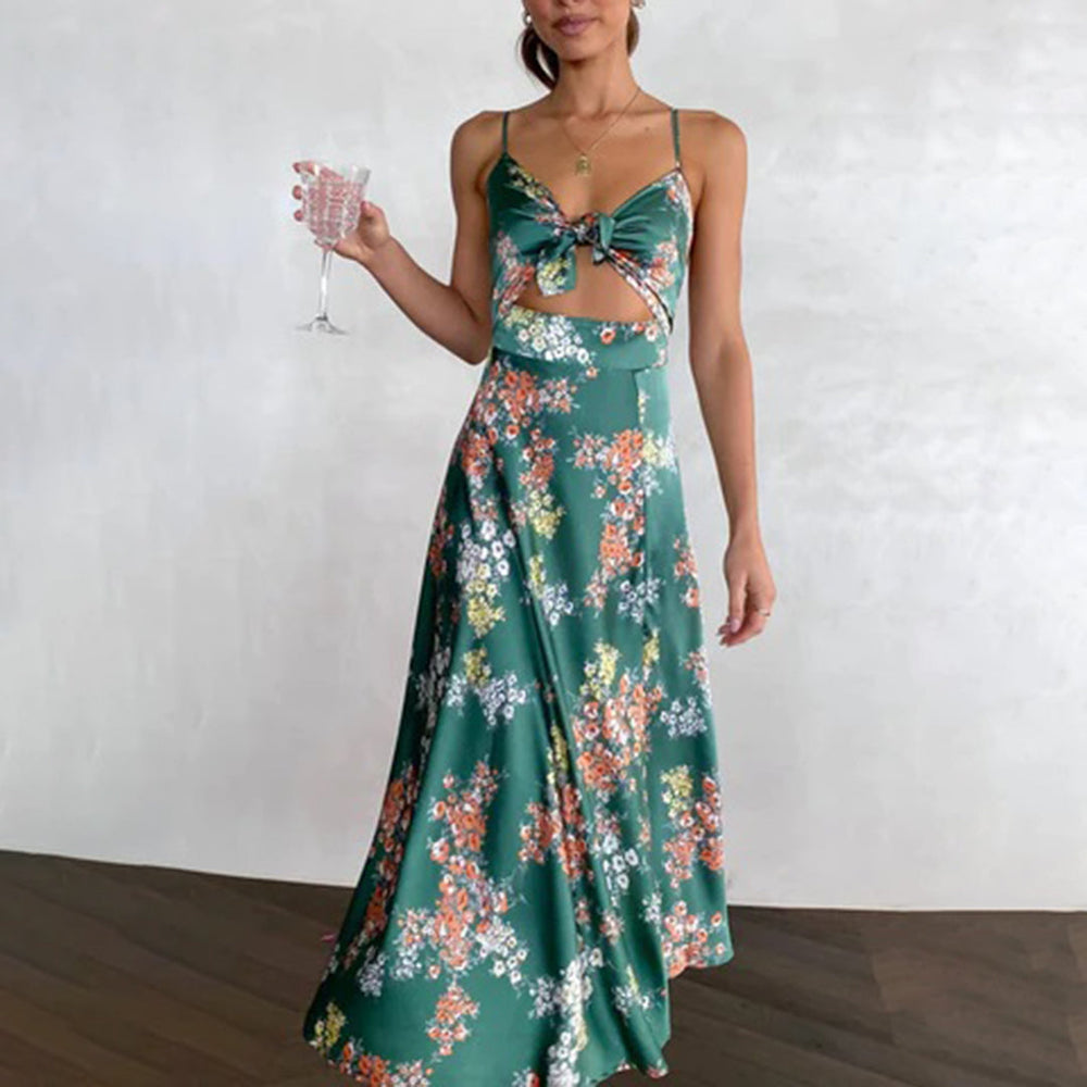 Vrouw in groene bloemenjurk met wijnglas, elegante zomeroutfit, boho-stijl, mouwloze maxi-jurk, casual chique mode, trendy dameskleding.