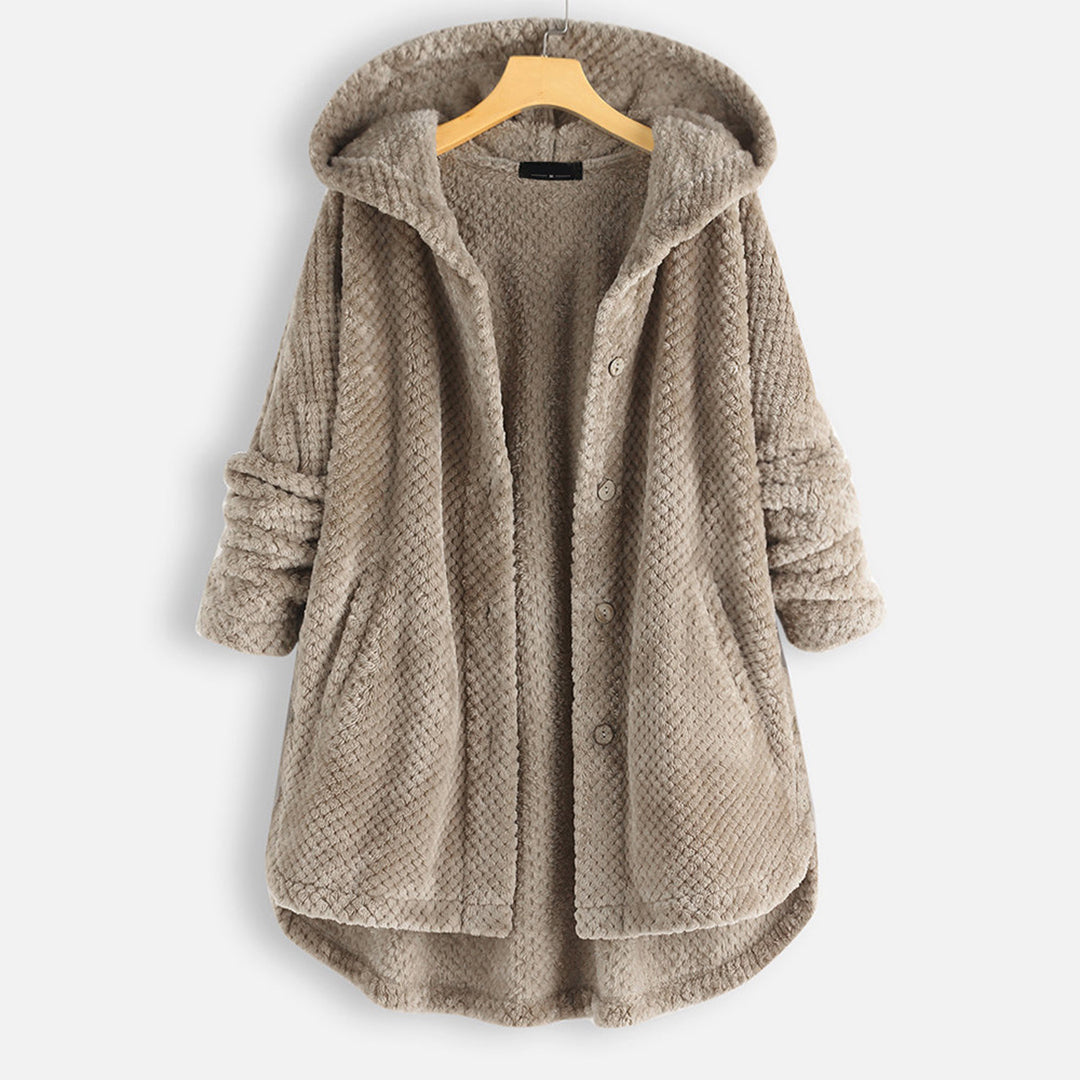 Khaki damesjas met capuchon, knopen en zakken, gemaakt van zacht, gewatteerd materiaal. Perfect voor herfst- en wintermode. Comfortabel en stijlvol.