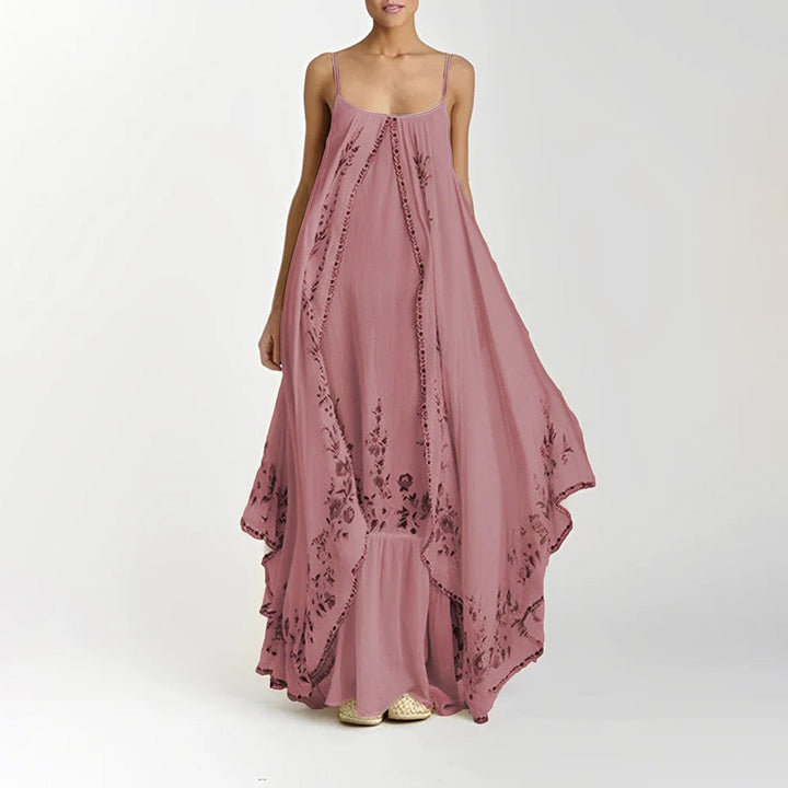 Roze maxi-jurk met bloemenprint, mouwloos en vloeiend ontwerp. Perfect voor zomerse gelegenheden. Comfortabele pasvorm en elegante uitstraling.