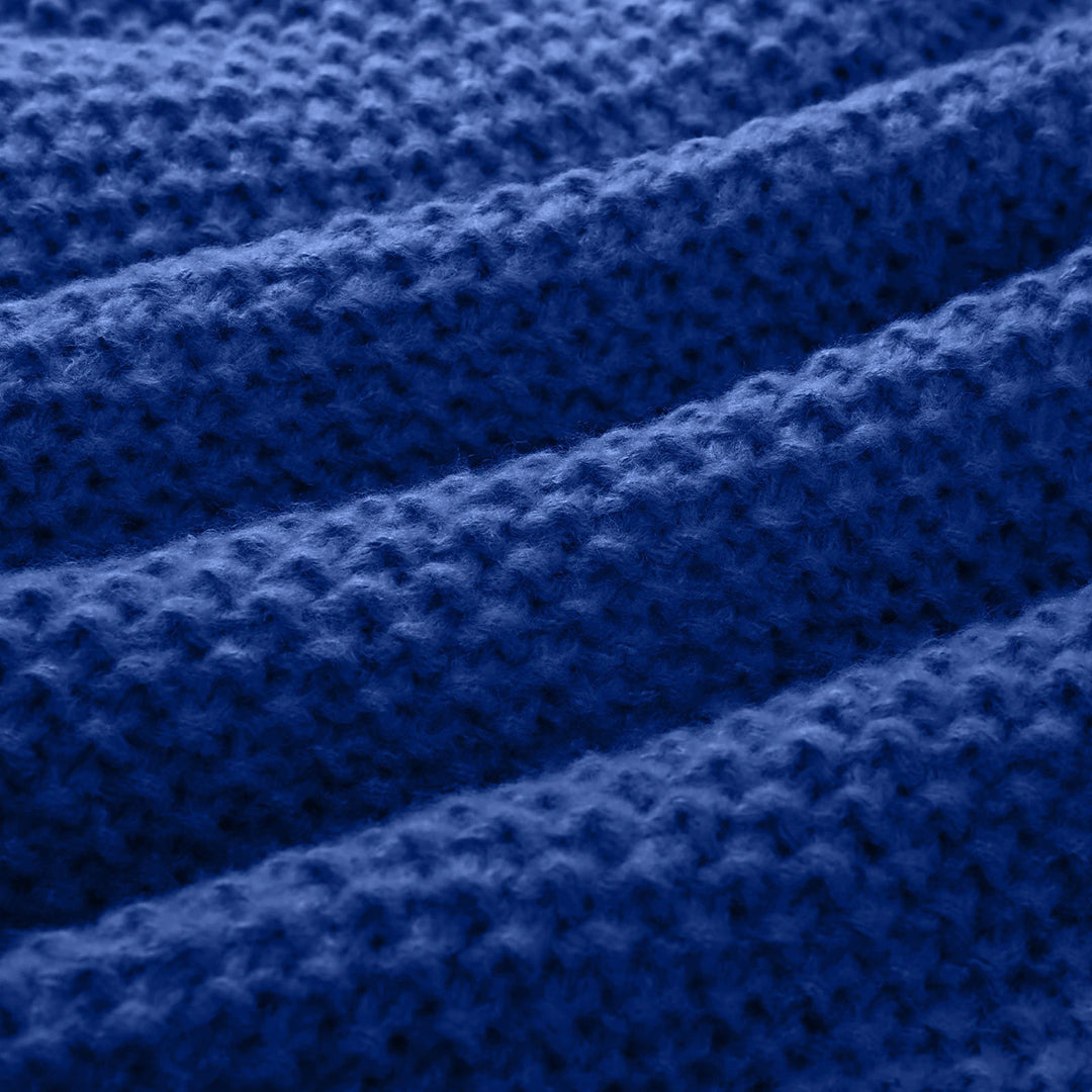 Blauwe gebreide stof close-up, textuur met golvende patronen. Perfect voor mode, interieur en ambachtelijke projecten. Hoogwaardige breisel.