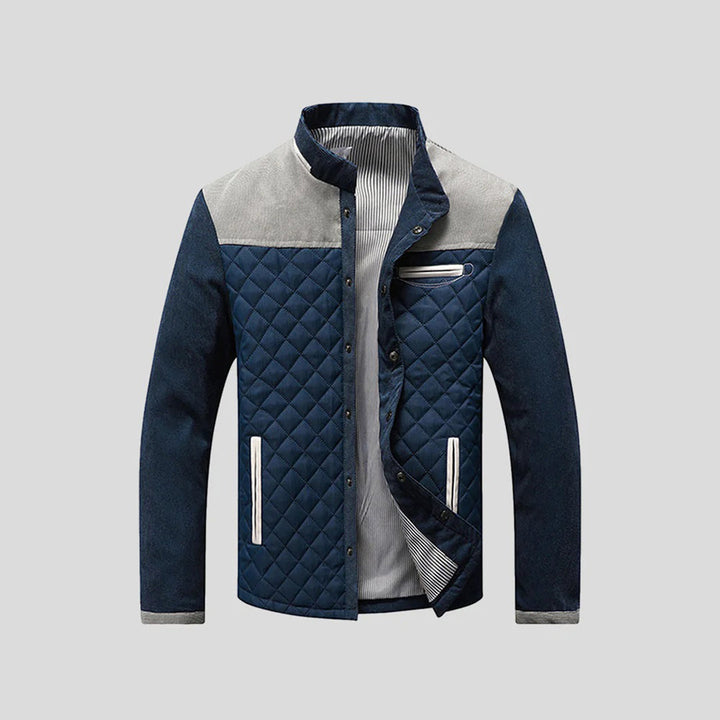 Blauwe gewatteerde herenjas met grijze accenten, ritssluiting en opstaande kraag. Stijlvolle winterjas voor heren, ideaal voor casual en outdoor gebruik.